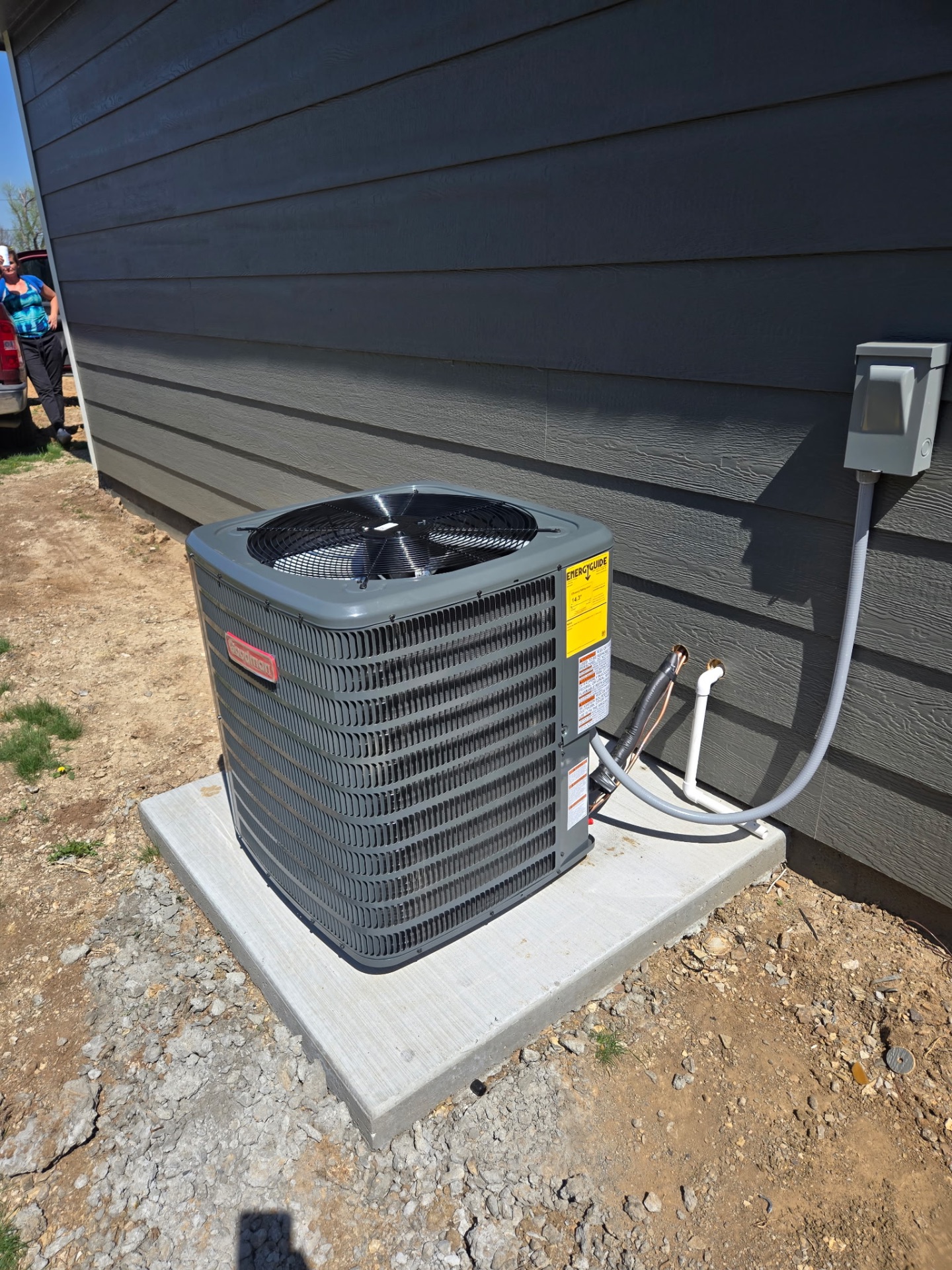 New Goodman AC condenser installed on concrete pad in Okmulgee, OK