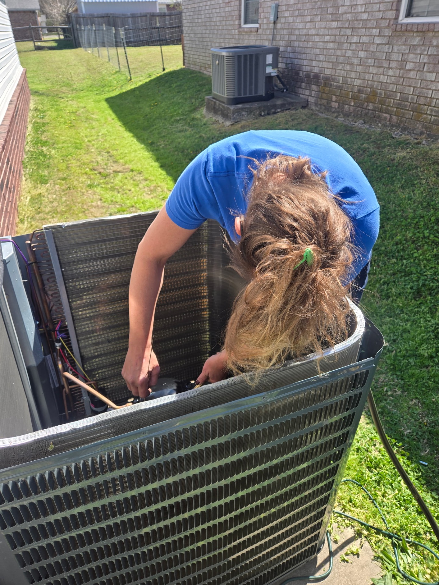 Tech inspecting evaporator coil during AC repair